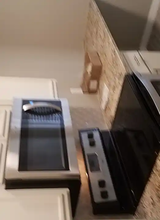 Completed white hexagon backsplash behind range and microwave in Waxahachie Texas