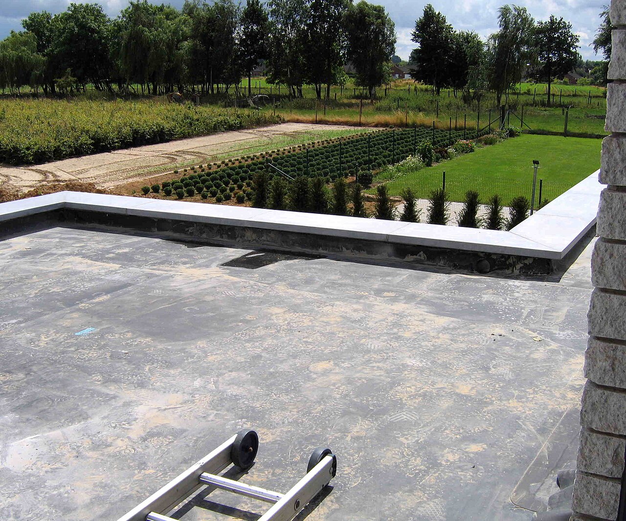 EPDM membrane reference on a low-slope roof with a perimeter wall