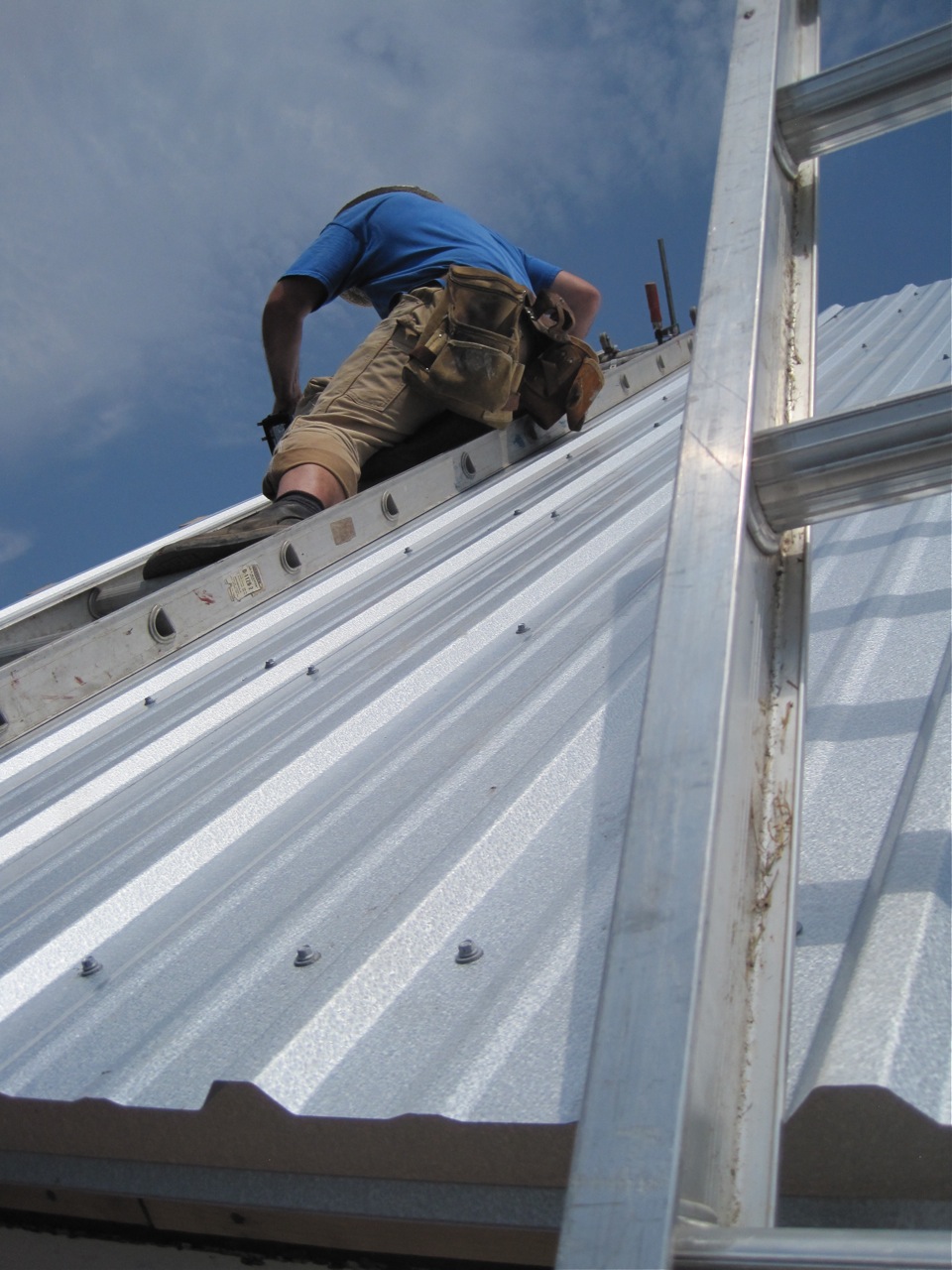 Installation reference showing silver ribbed metal panels with visible screw heads