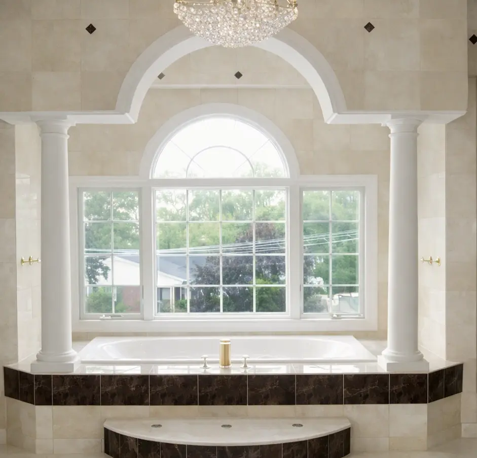 Luxury soaking tub with columns and arched window in Mansfield Texas