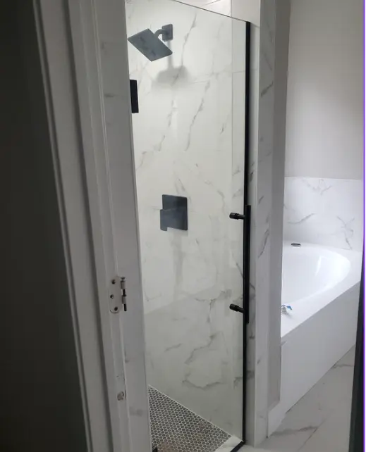 Marble-look walk-in shower with black fixtures in Fort Worth Texas