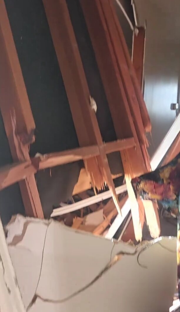 Damaged interior framing exposed during demolition