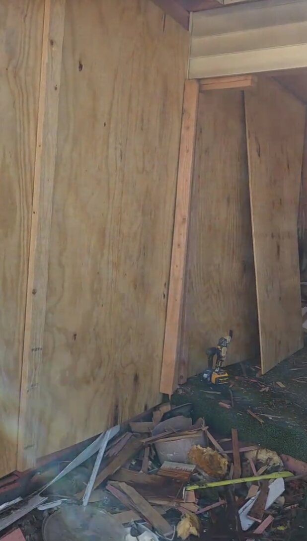 Interior demolition with wall sheathing and framing exposed
