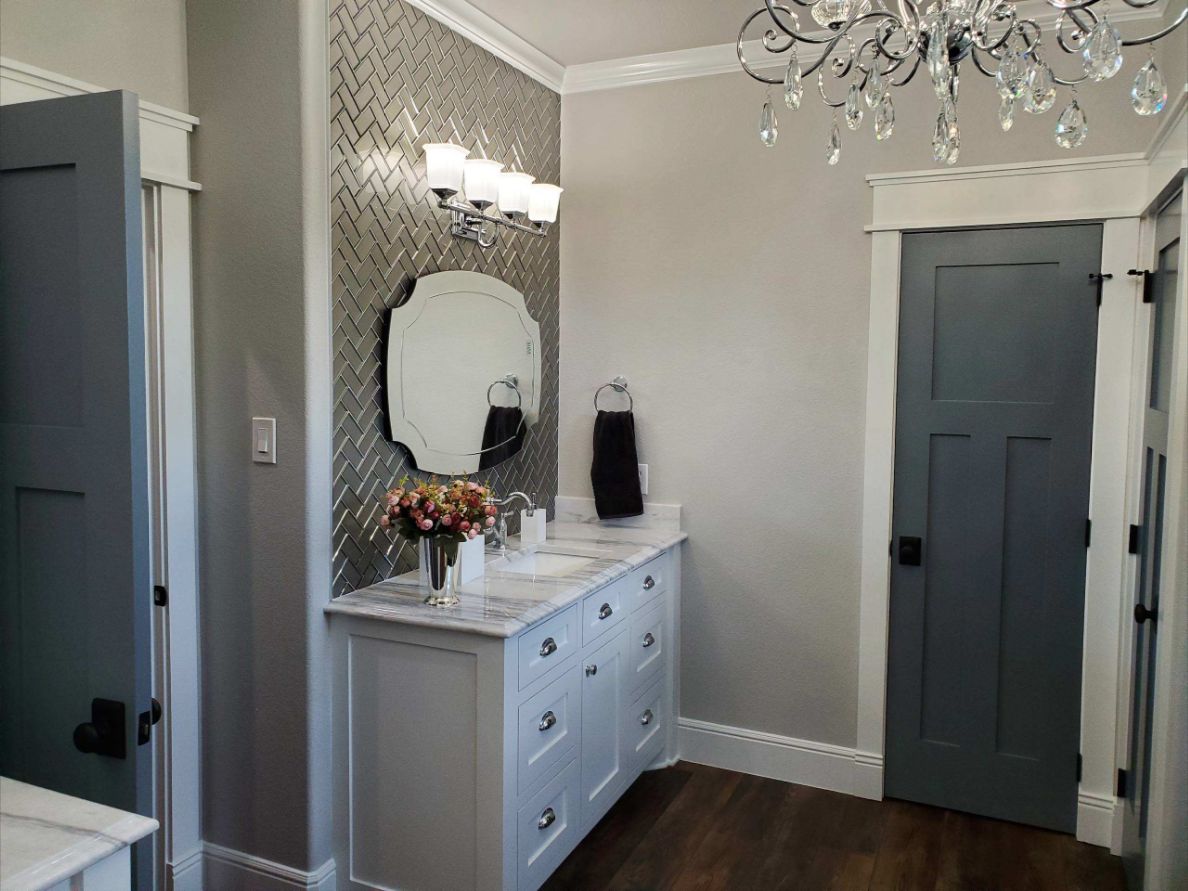 Custom bathroom vanity, herringbone accent wall and gray craftsman doors