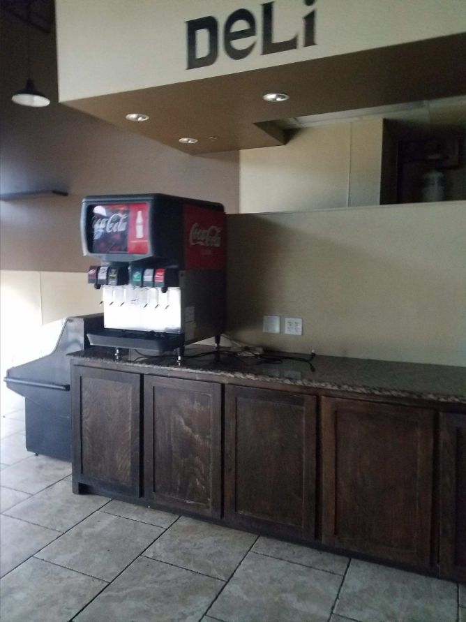 Deli service counter, cabinets, tile floor and lighting after a commercial finish-out