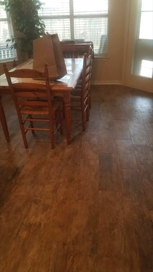 Dark wood-look plank flooring installed in a dining room in Dallas-Fort Worth