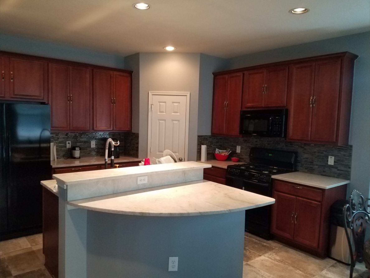 Kitchen remodel with wood cabinets, tile backsplash and center island