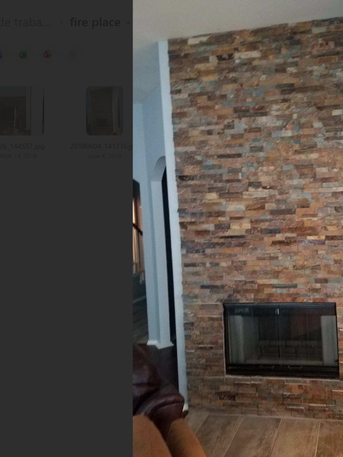 Finished floor-to-ceiling stacked-stone fireplace surround in a Dallas-Fort Worth home
